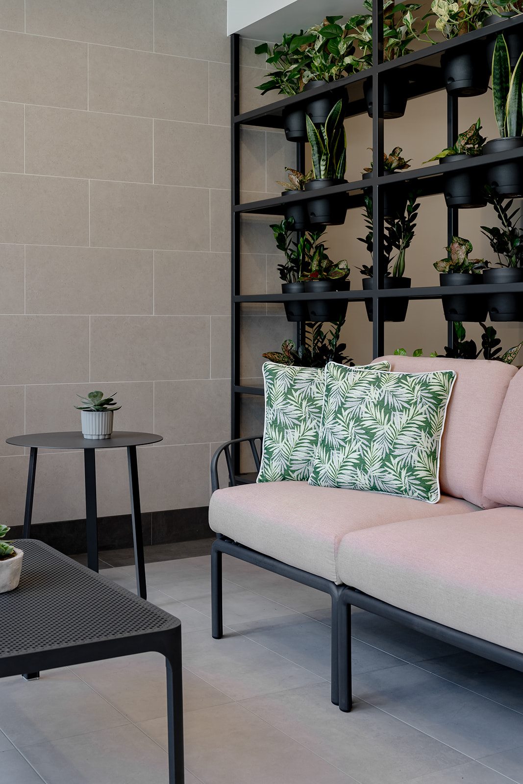 Commercial interior with pink armchairs and shelving