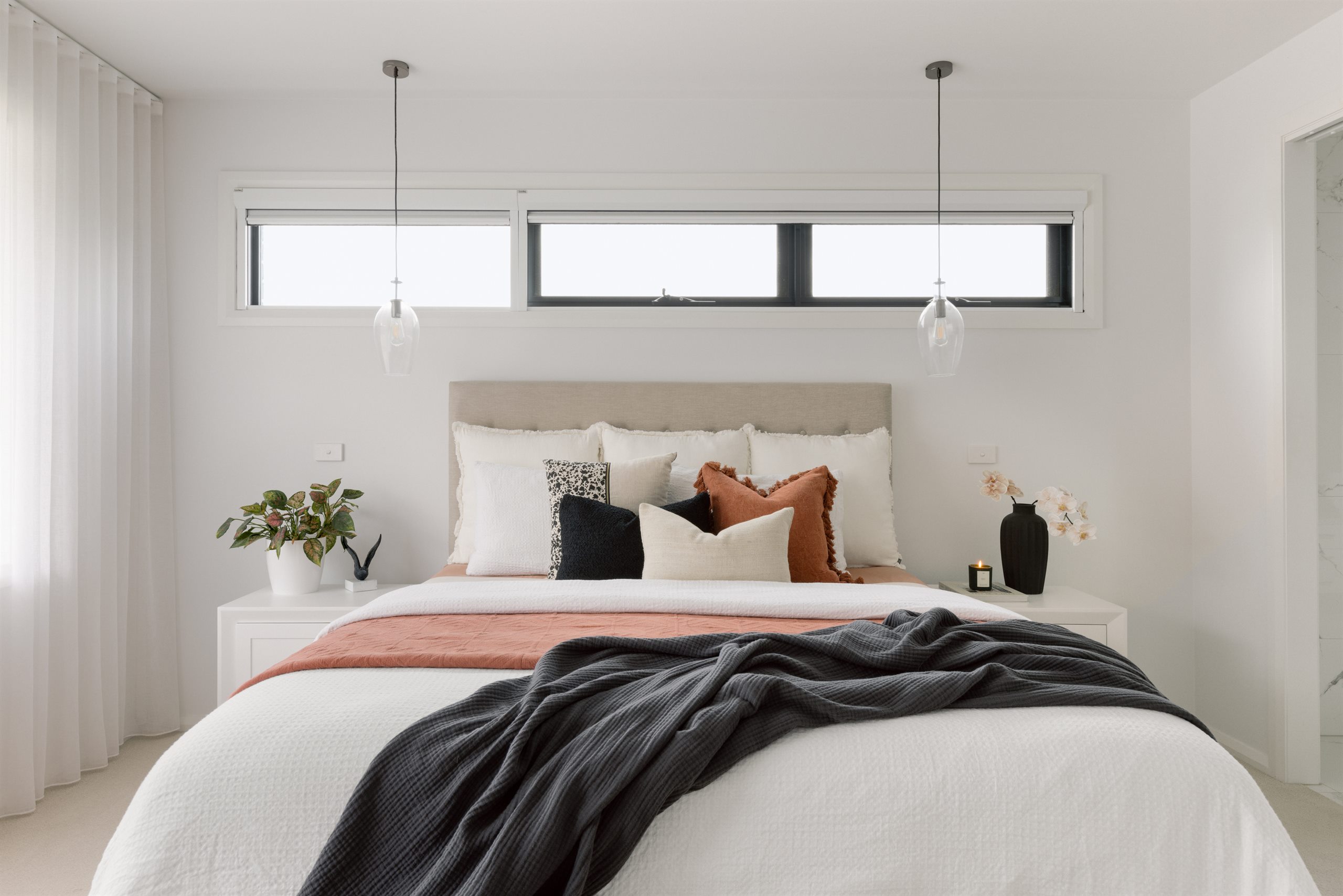 Styled bedroom with soft linen and pendant lights