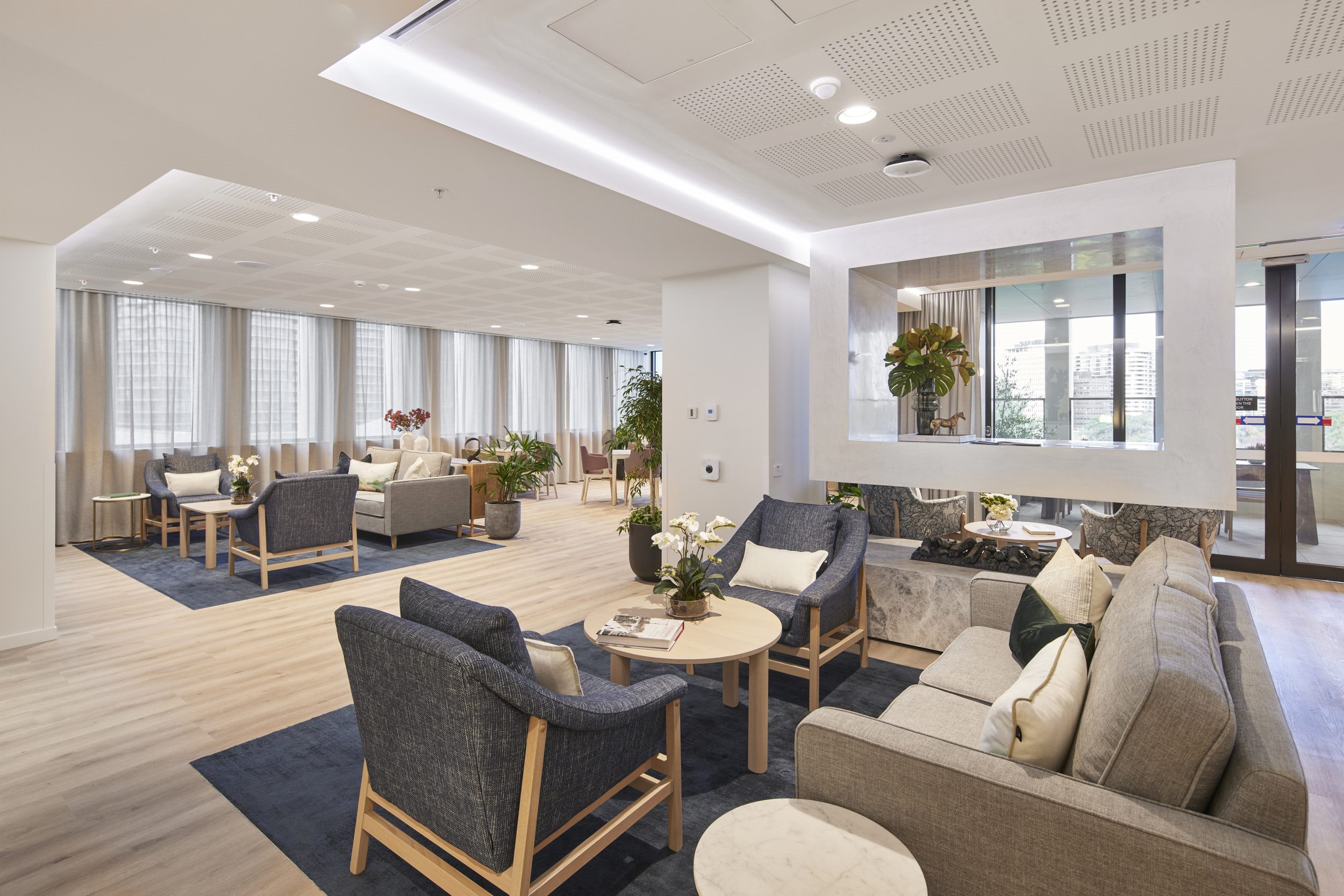 Commercial lounge with armchairs and timber floors