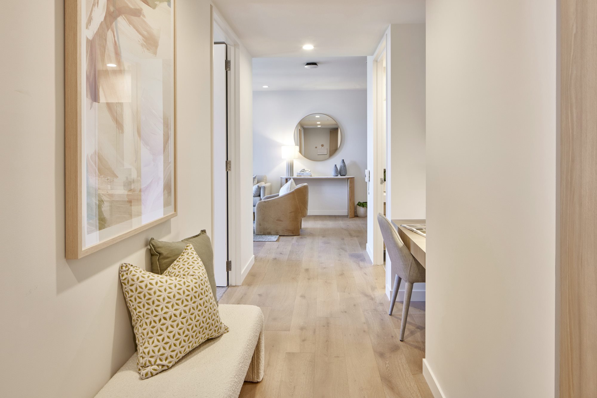 Light-filled hallway with upholstered bench